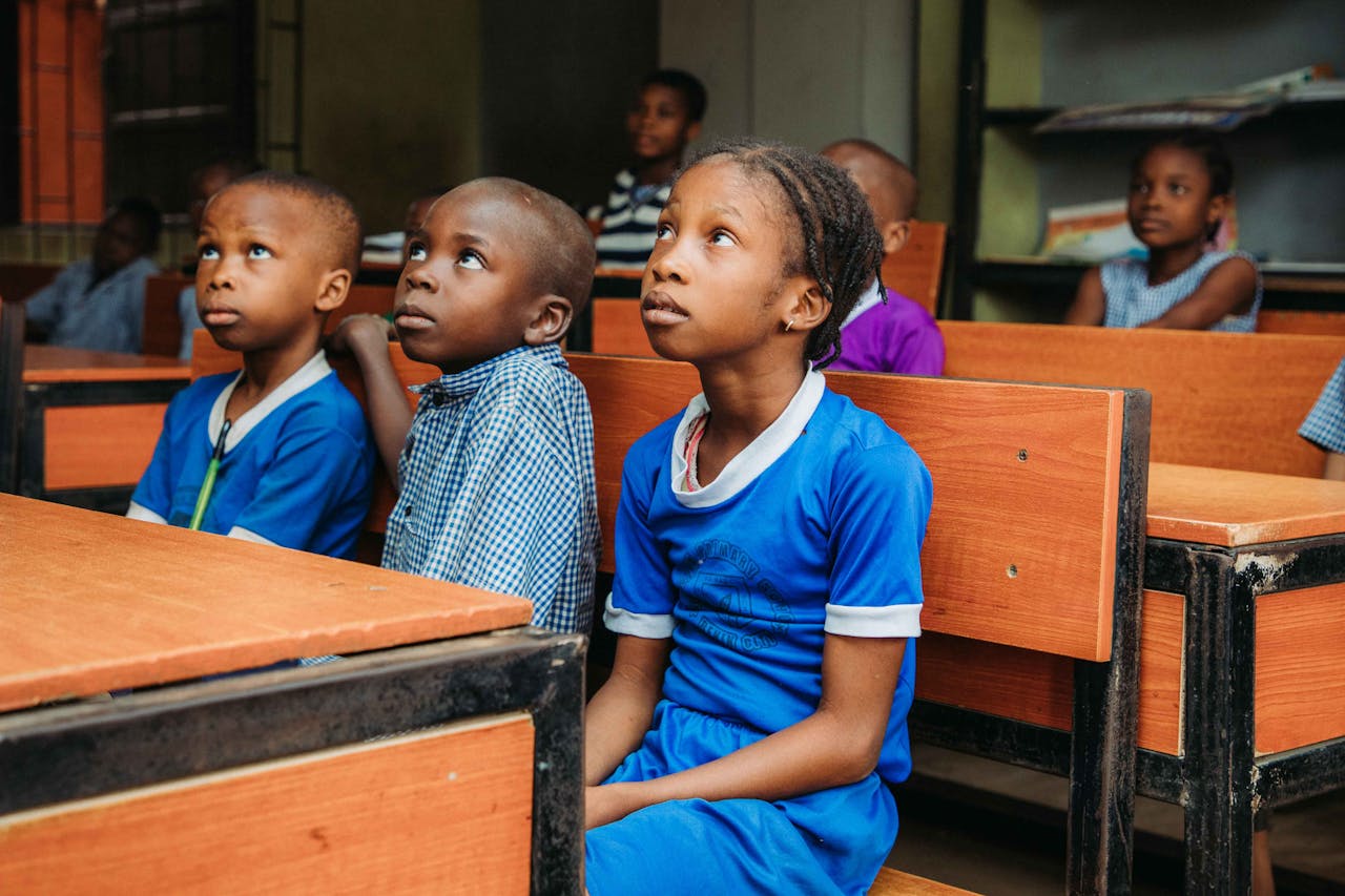gallery-5 Children attentively listening in a classroom environment.