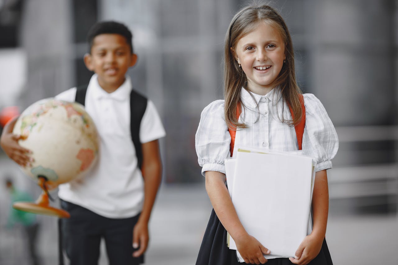 services-img Happy students in school uniforms with books and globe, ready for learning adventures.
